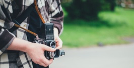 person adjusting lenses of  a camera