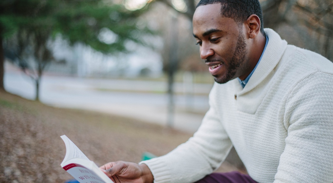 faculty reading in a park